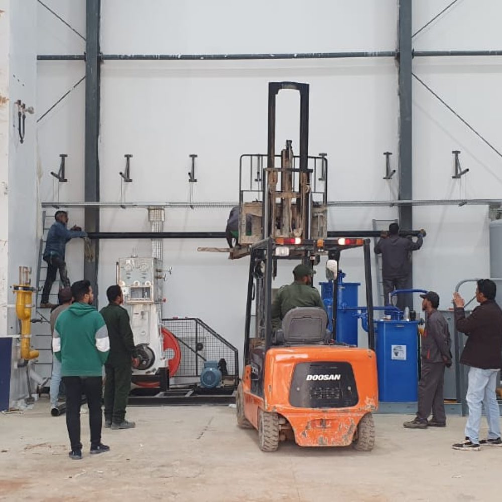 Forklift and workers assembling equipment on the production floor
